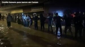 Pessoas fazem “cordão humano” em Canoas para puxar barco e ajudar no resgate dos moradores