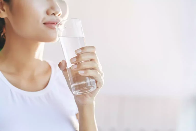 unrecognizable woman carrying glass of water to mouth 1536x1025 1