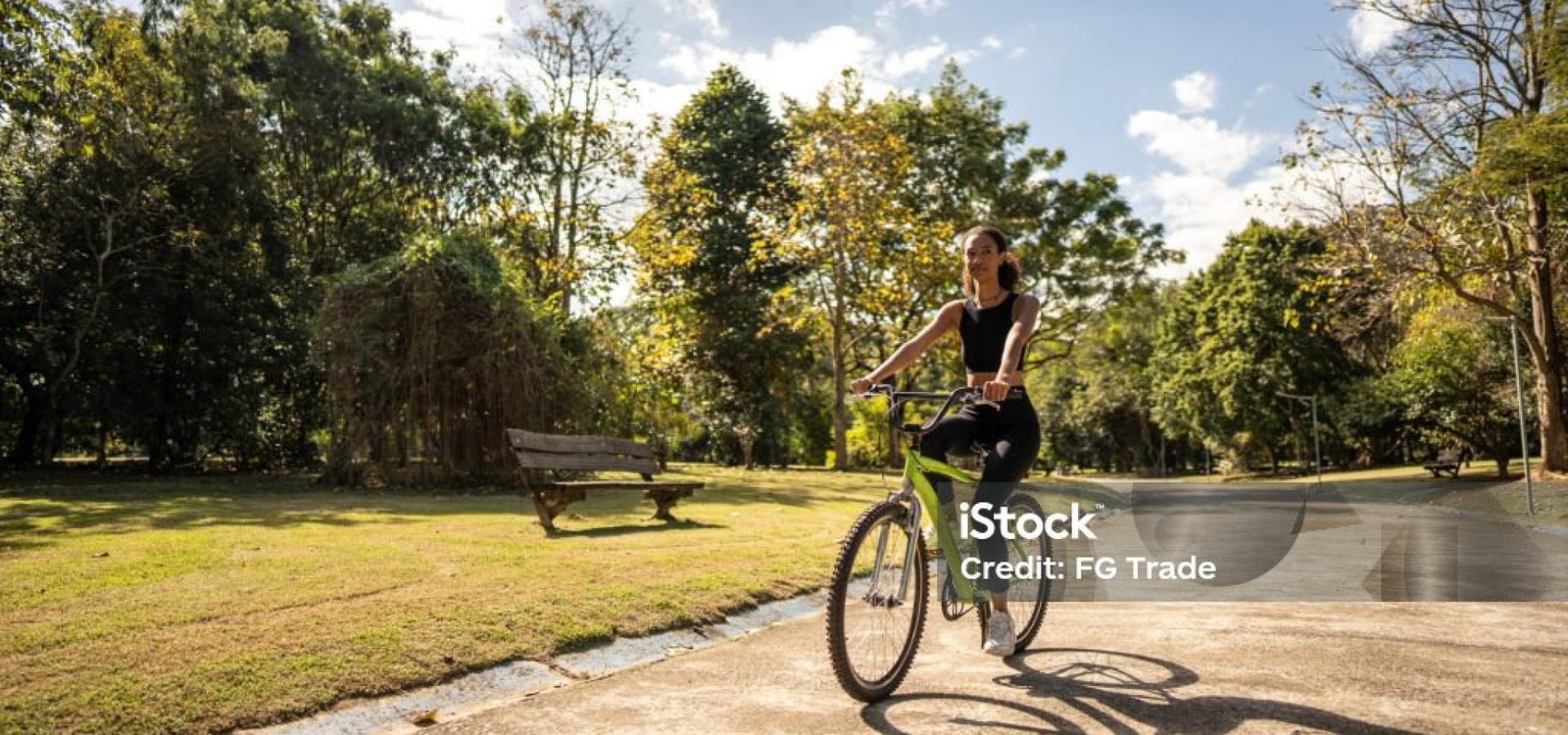 Mid adult woman cycling on the public park